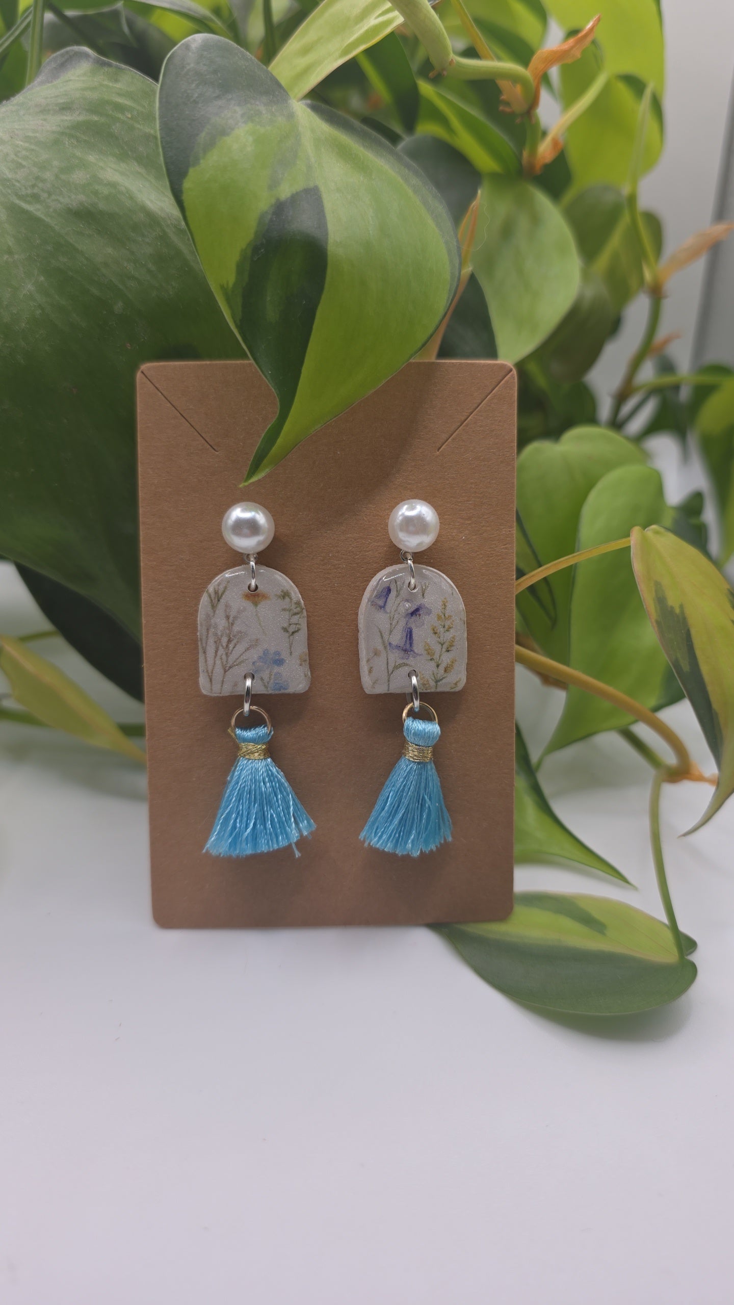 Pearl and floral clay earrings with blue tassels